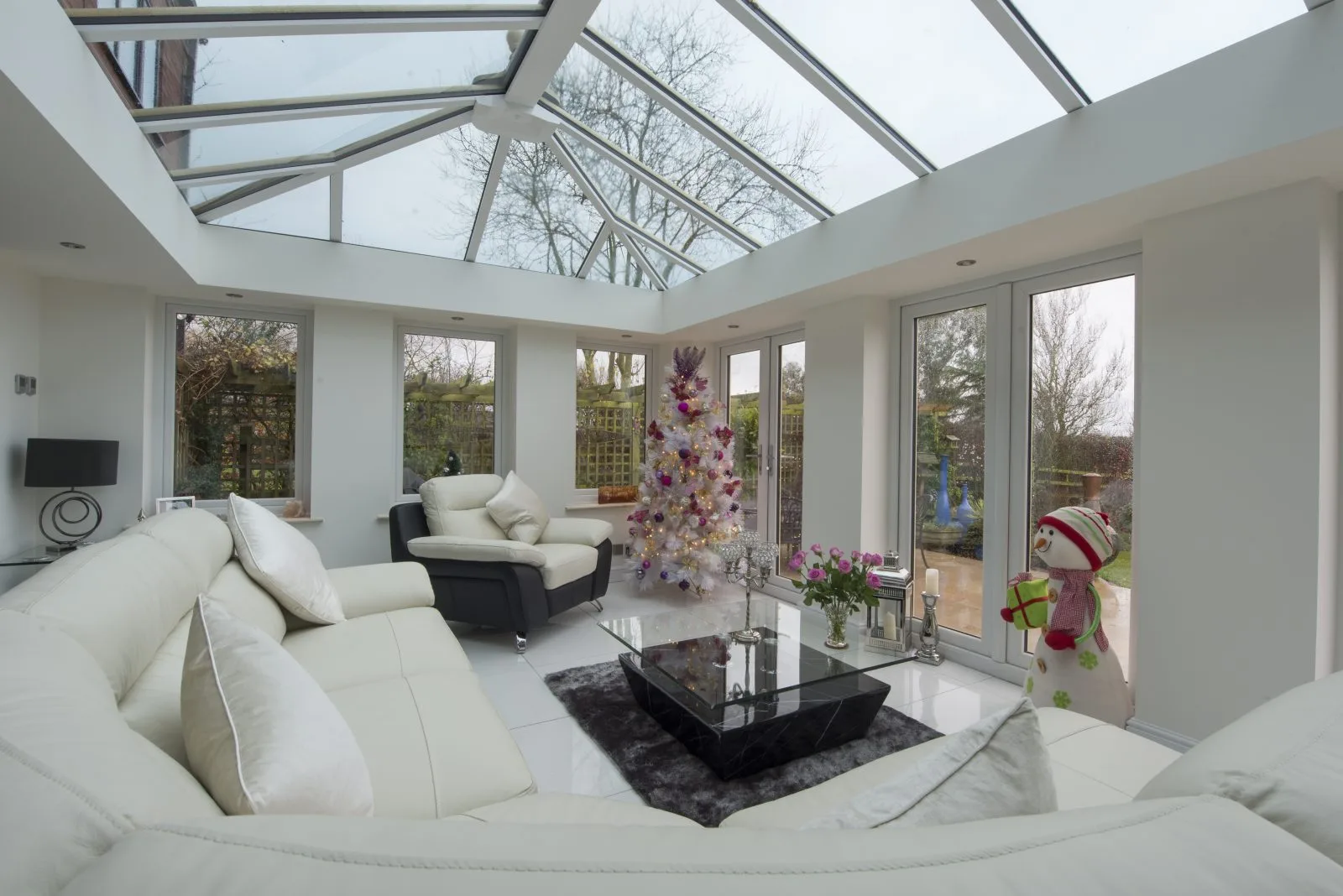 Orangery extension with brick pillars and lantern roof