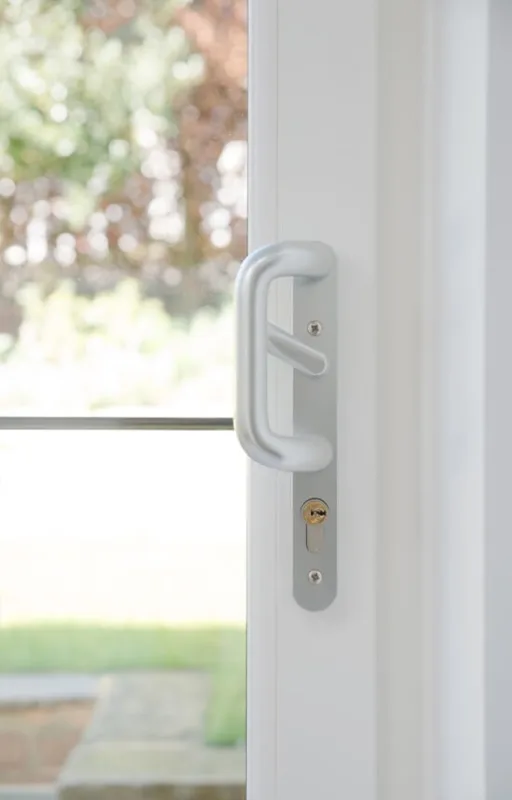 Close-up detail of sliding patio door handle and frame