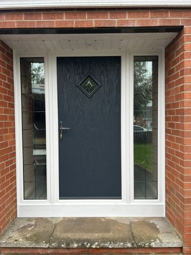 close-up of black composite front door installation