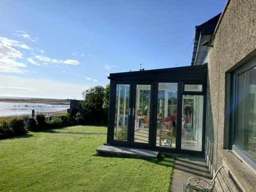 external view of a newly installed conservatory by turkington, featuring new french doors