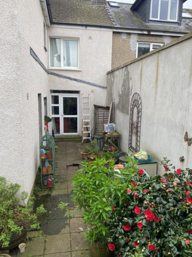 an unused space in a back garden, prior to conservatory installation