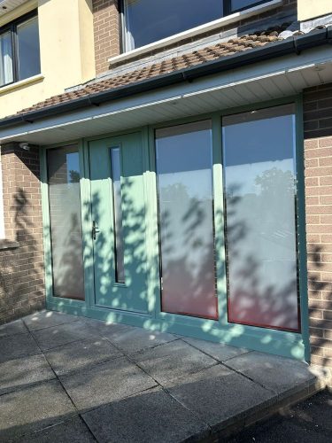 newly-installed chartwell green porch with chartwell green front door