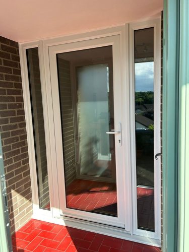 white upvc front door within newly-installed chartwell green porch