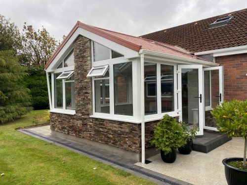 ultraroof upvc conservatory extension with opened white upvc french doors