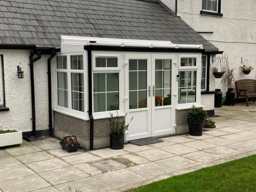 white upvc conservatory with white upvc french doors