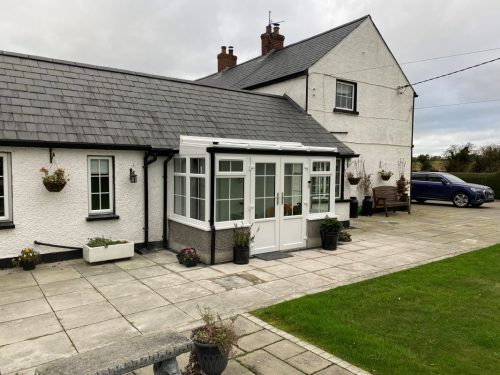 white upvc conservatory with white upvc french doors