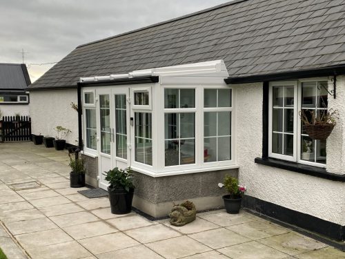 white upvc conservatory with white upvc french doors