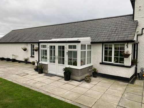 white upvc conservatory with white upvc french doors