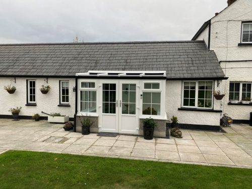 white upvc conservatory with white upvc french doors