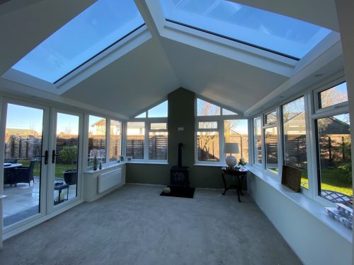 internal view of upvc conservatory with white upvc french doors